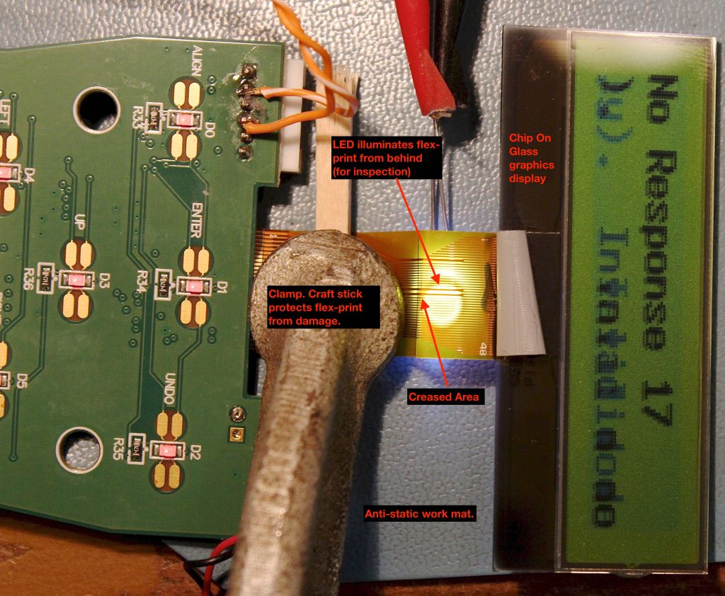 Bench testing. One can notice the creased area of the flex-print cable. A single LED was added to backlight the flex-print while looking for breaks.